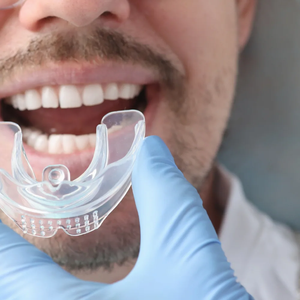 Man getting fitted for mouthguard